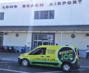 Mosquito Joe Service van parked in front of Long Beach Airport